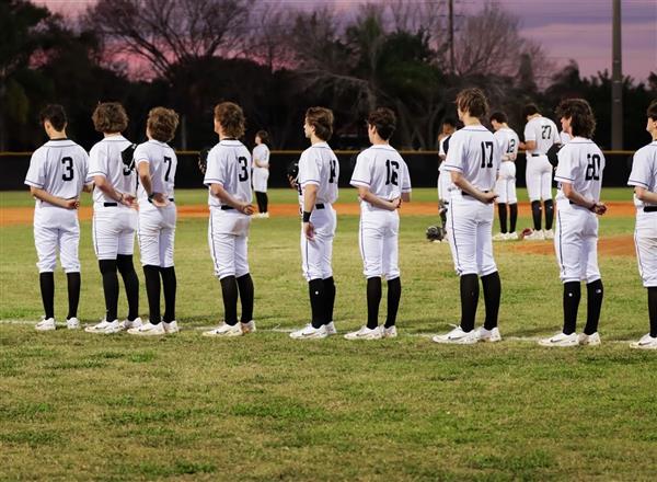 Baseball team standing during national anthem