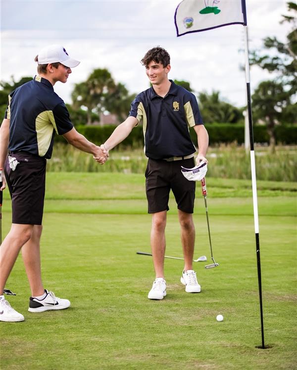 Boys golf players shaking hands