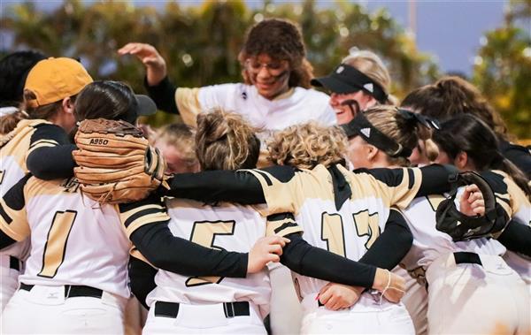 Softball players in team huddle